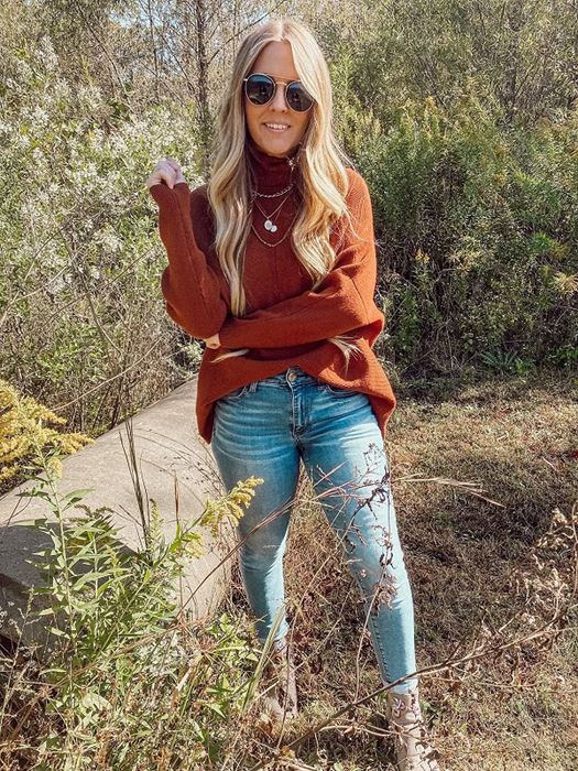 A reviewer wearing the orange turtleneck.