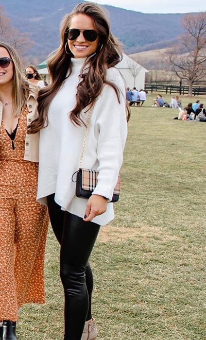 another reviewer wearing the white sweater with black pants