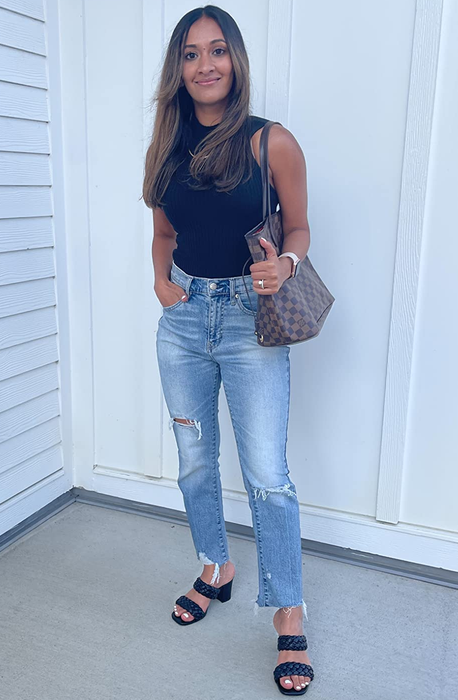 A full-length view of a reviewer sporting the black sandals.