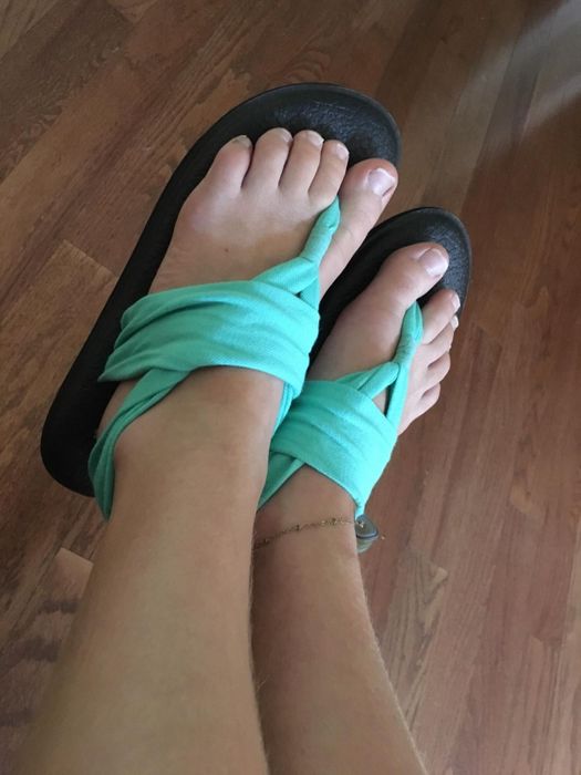 A reviewer wearing the teal version of the shoes.