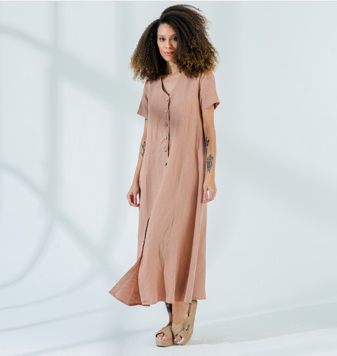 A model wearing a beige button-up, short-sleeve linen maxi dress.