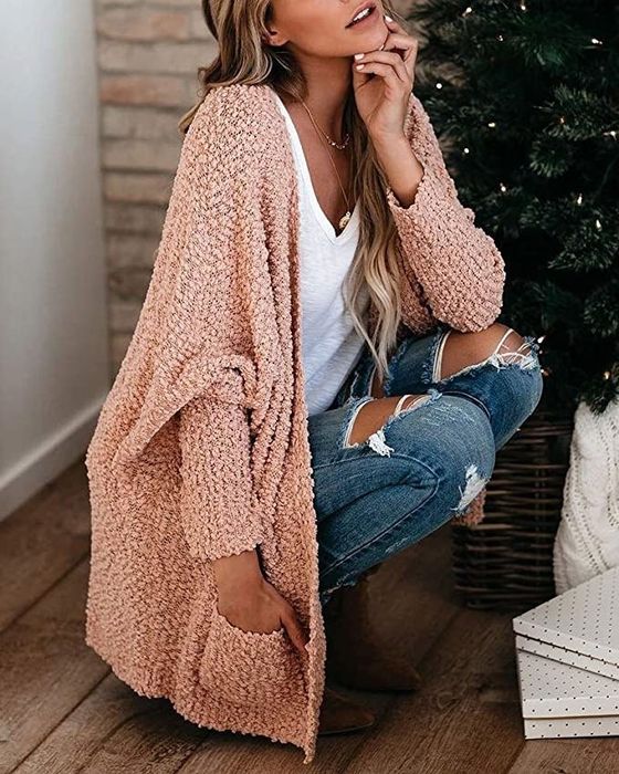 A model showcasing the pink cardigan.