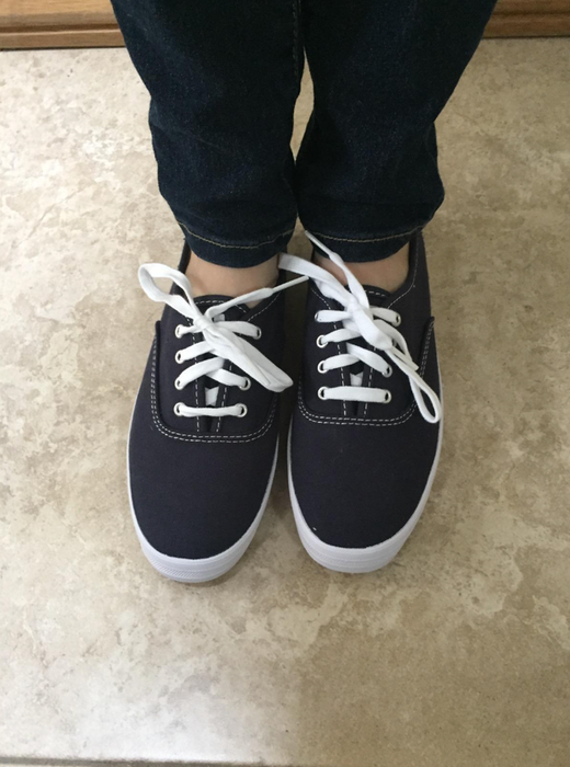 reviewer showcasing the navy-colored shoes