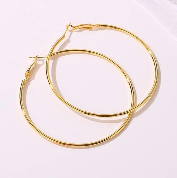 Gold hoop earrings neatly stacked together
