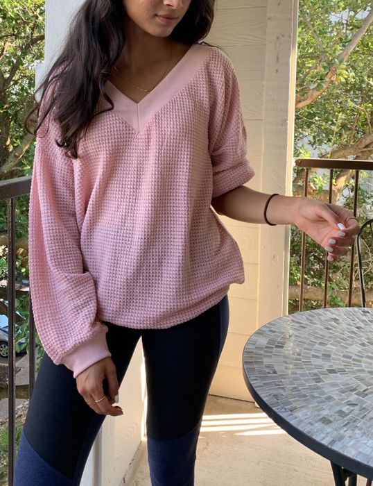A reviewer rocking the sweater in pink.