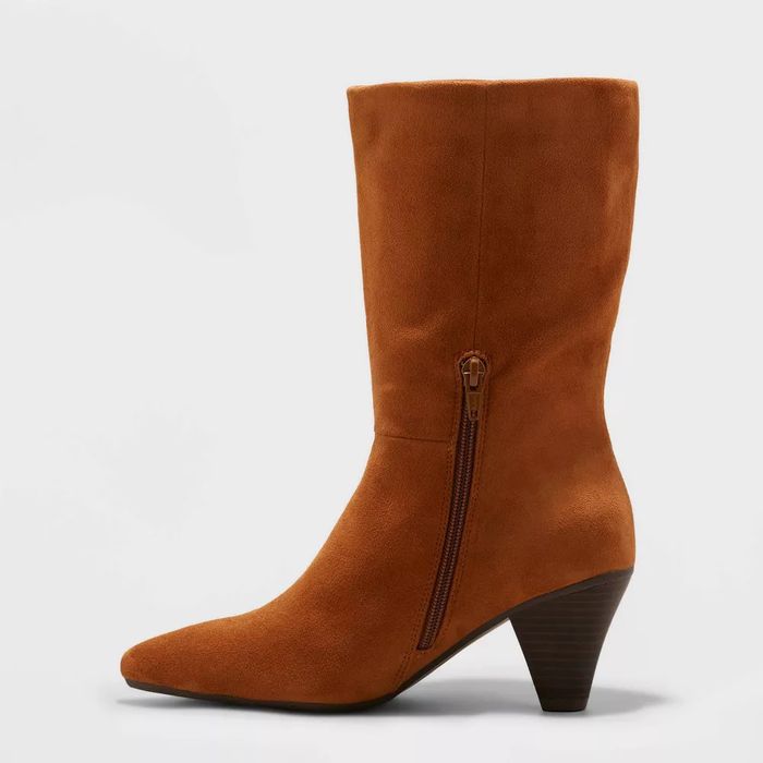 Mid-calf suede boot featuring a pointed toe and a side zipper