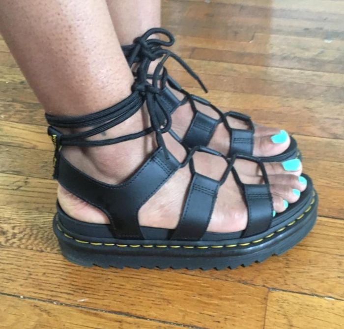 A photo of the reviewer standing while wearing sandals.