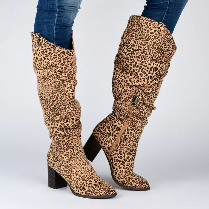 A model showcasing leopard-print knee-high boots with block heels