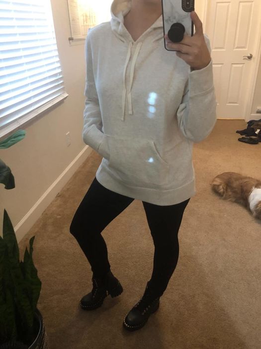 Reviewer wearing a white Amazon Essentials pullover hoodie