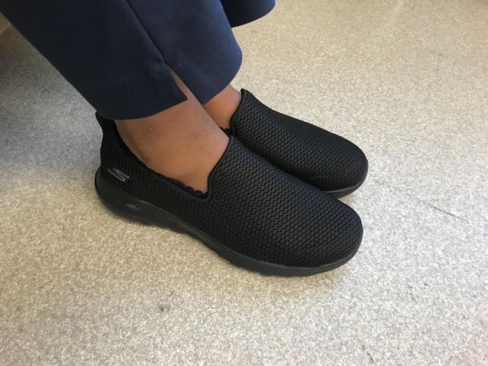 Reviewer wearing black Skechers GoWalk Joy sneakers