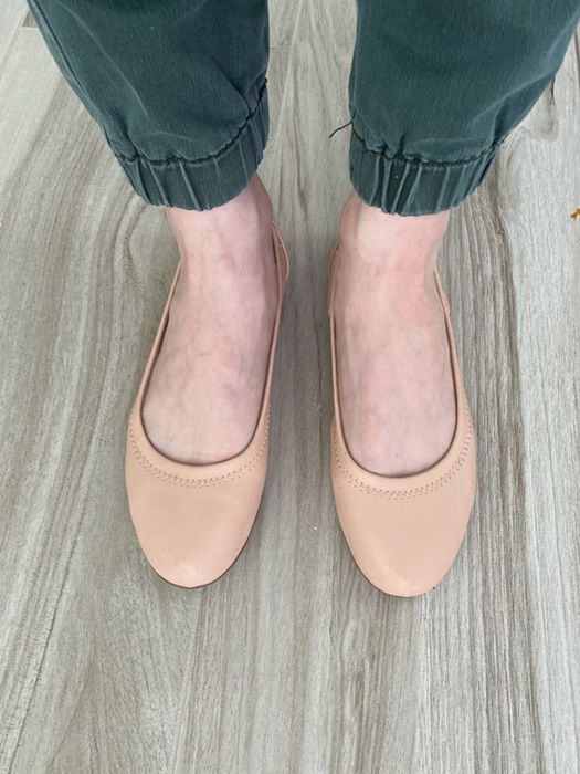 Reviewer wearing blush-colored Amazon ballet flats