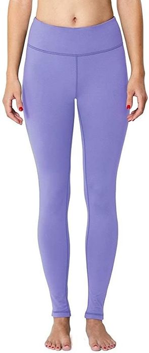 A model showcasing the leggings in a bold paisley purple pattern