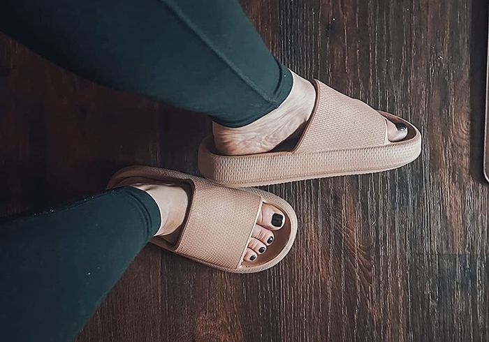 A reviewer wearing the brown sandals