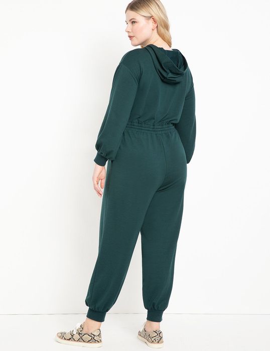 A back view of the same model wearing the sweatsuit in pine grove.