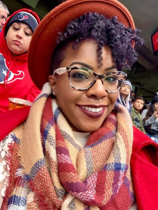 A reviewer styled in the red-orange scarf.