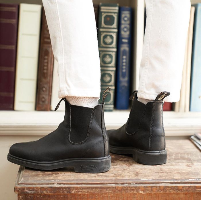 The model is wearing a pair of black Blundstone boots.