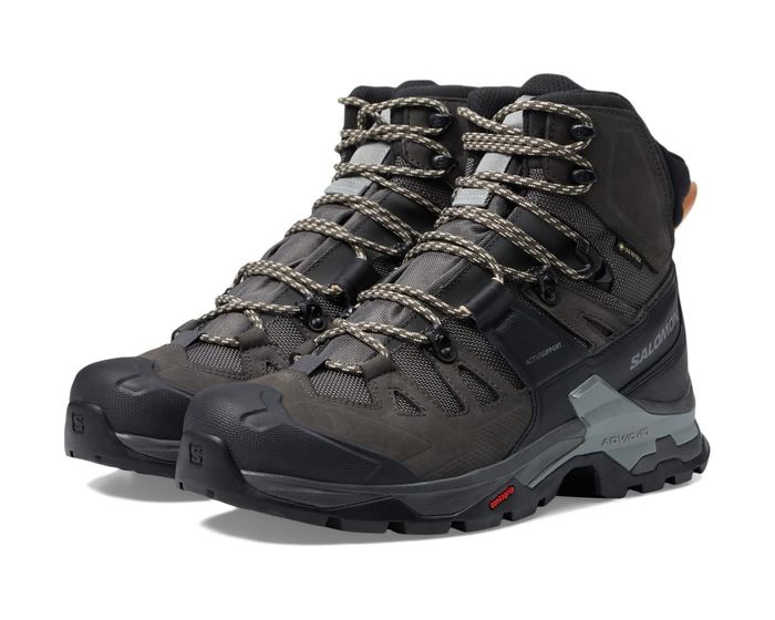 A pair of Salomon hiking boots showcased against a white background.