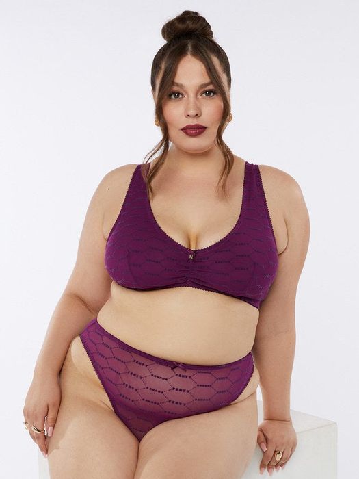 A model is showcasing the dark purple bralette.