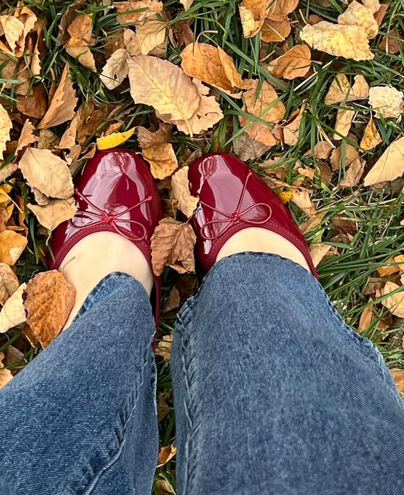 A reviewer showcasing the burgundy shoes