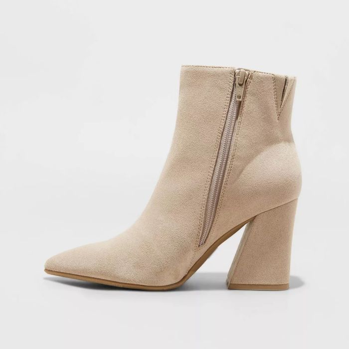 Beige ankle boot featuring a pointed toe and a block heel.