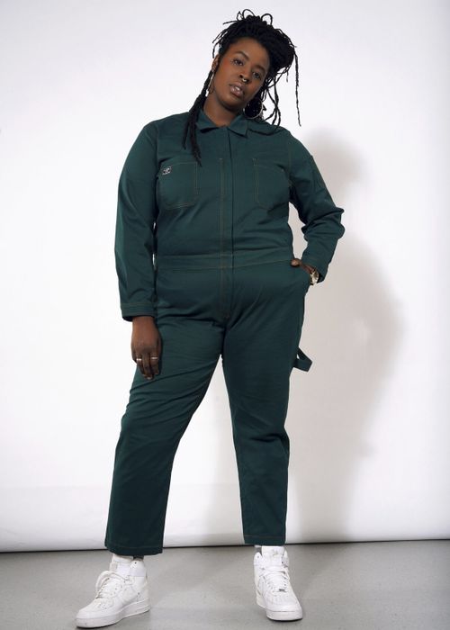 A different model showing off the jumpsuit in vibrant botanical green