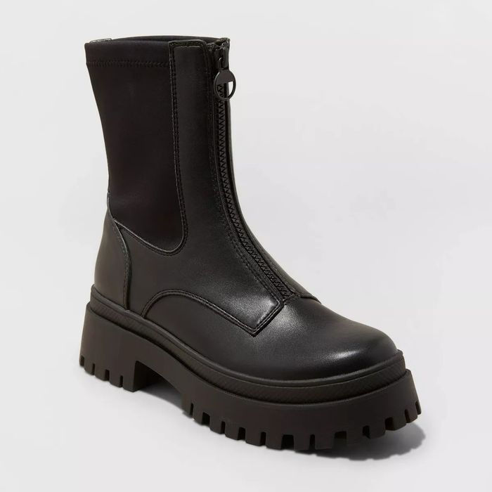 black platform boots featuring a front zipper