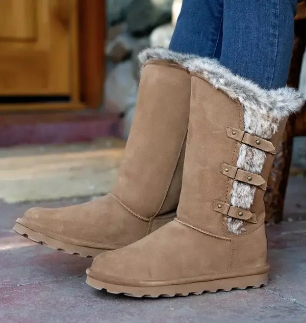A pair of brown boots featuring a plush, furry lining.
