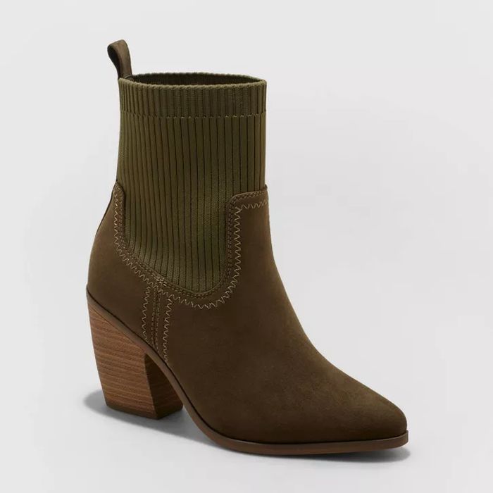 Olive green sock boot featuring a brown pointed toe and a stacked heel.