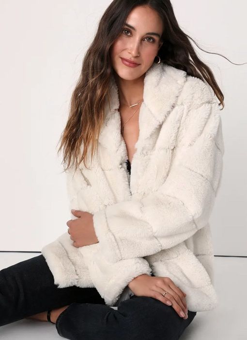 a model wearing the chic white fur coat
