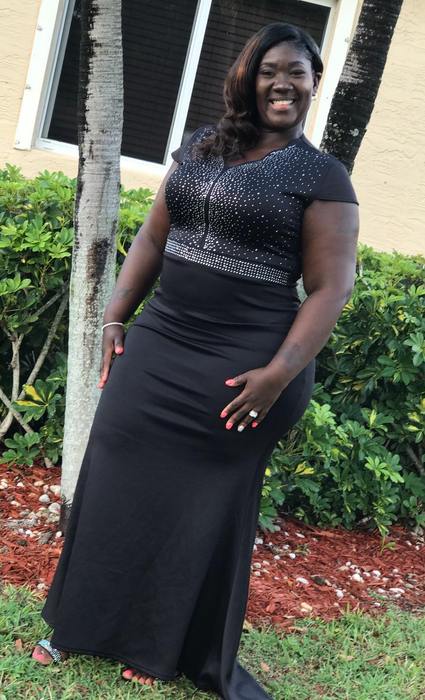 A reviewer in a long black dress outdoors