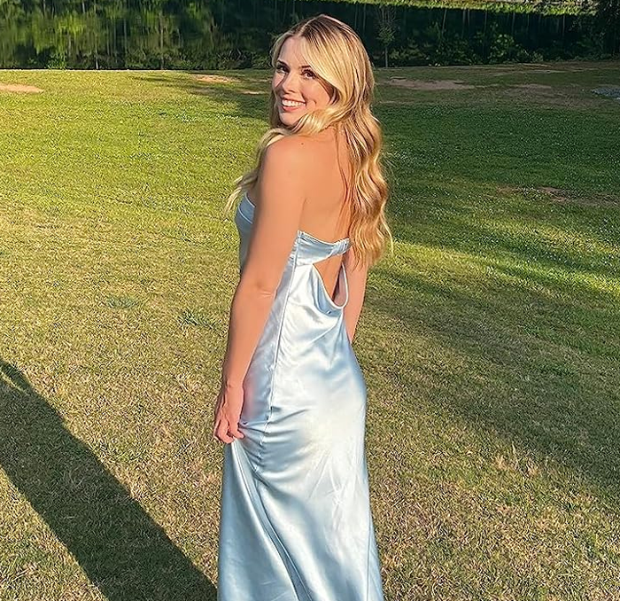 reviewer in a sleek satin slip dress featuring a stylish tie-back design