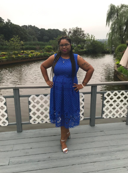 A reviewer wearing the thick-strap lace dress in blue