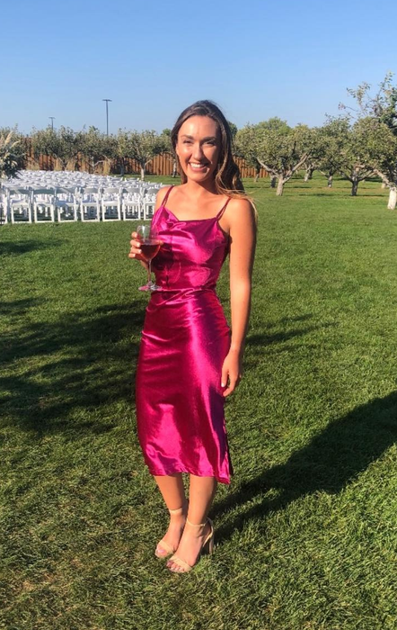 A reviewer posing in a pink outfit