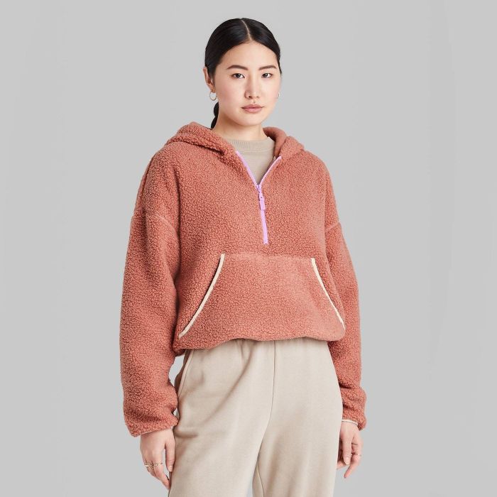 model wearing pink half zip sherpa anorak
