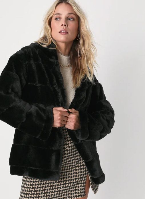 a model showcasing the elegant black coat