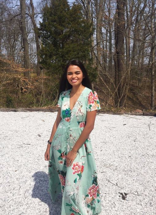 A reviewer in a mint green dress