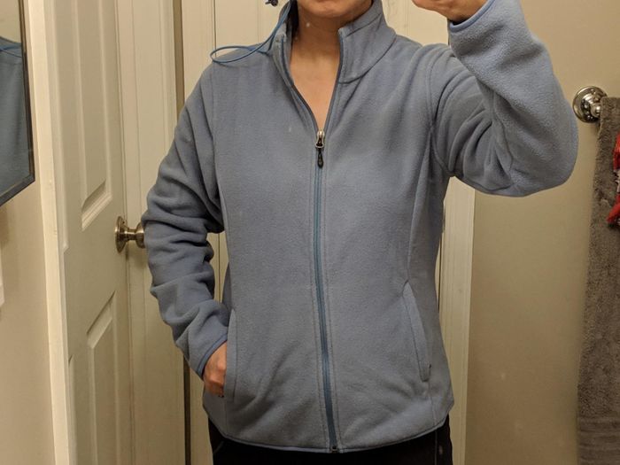 A reviewer wearing a grey fleece jacket