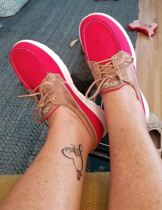 A reviewer wearing the red Skechers boat shoes.