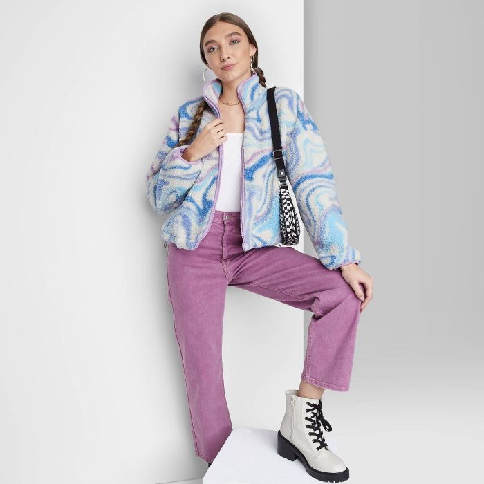 model wearing a blue swirl sherpa jacket