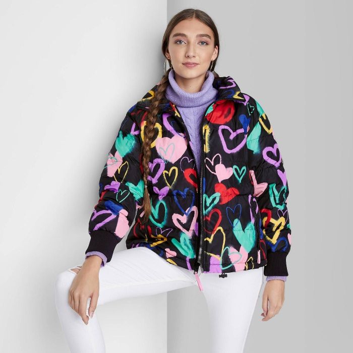 model wearing black puffer jacket with colorful graffiti-style heart