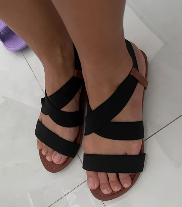 A reviewer wearing the black sandals