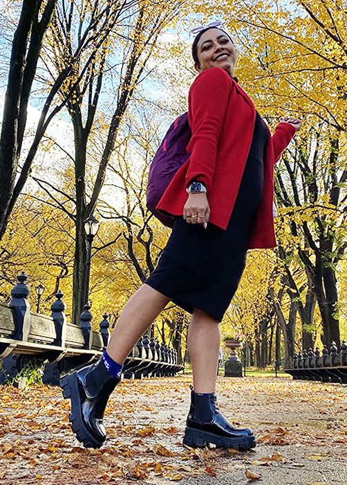 a reviewer wearing the stylish black chunky boots