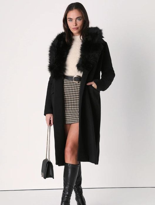 A model showcasing the chic black coat.
