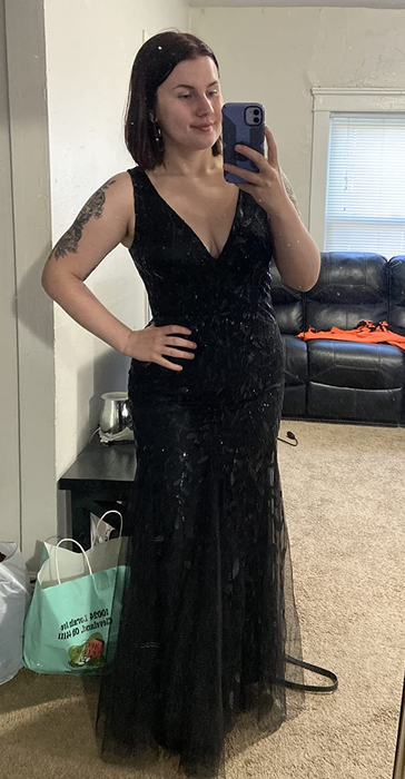 A reviewer in a long black dress