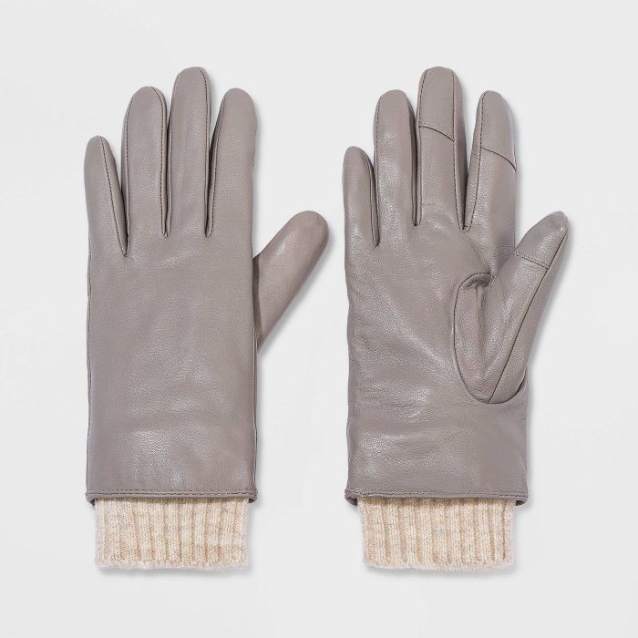 pair of gray leather gloves with cream colored knit cuffs