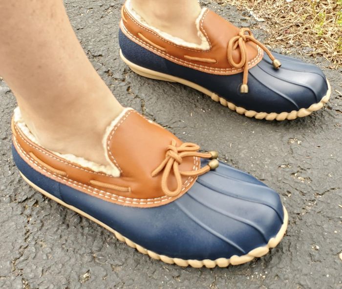 reviewer sporting brown and blue ankle duck shoes