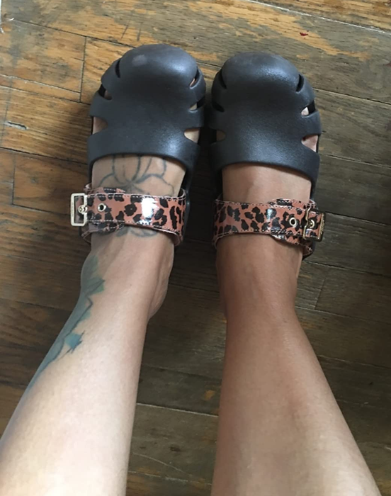 top view of black clogs with a cheetah print strap