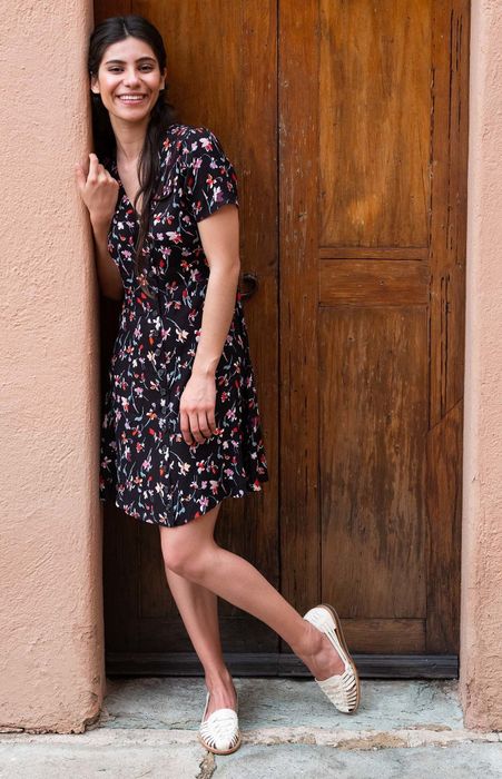 A model wearing a printed dress and the woven huarache sandals in a beautiful natural shade