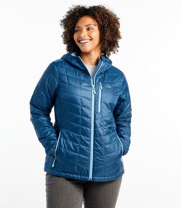 A model wearing a blue jacket over grey pants