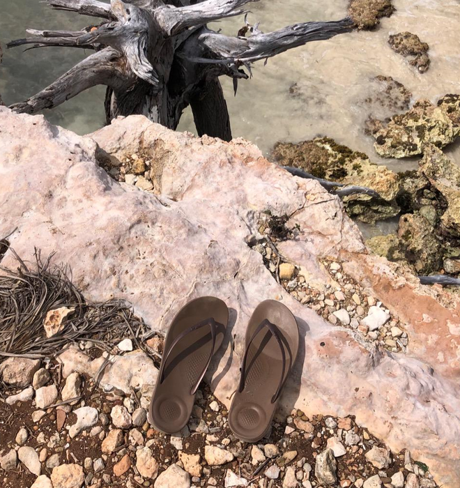 a reviewer’s photo of the brown FitFlops on a cliff overlooking water